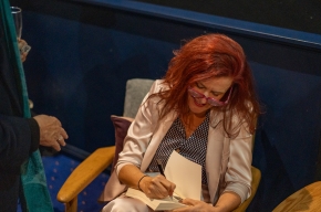 Rachael Mogan McIntosh signs copies of her novel. Photo by Greg Jackson. 